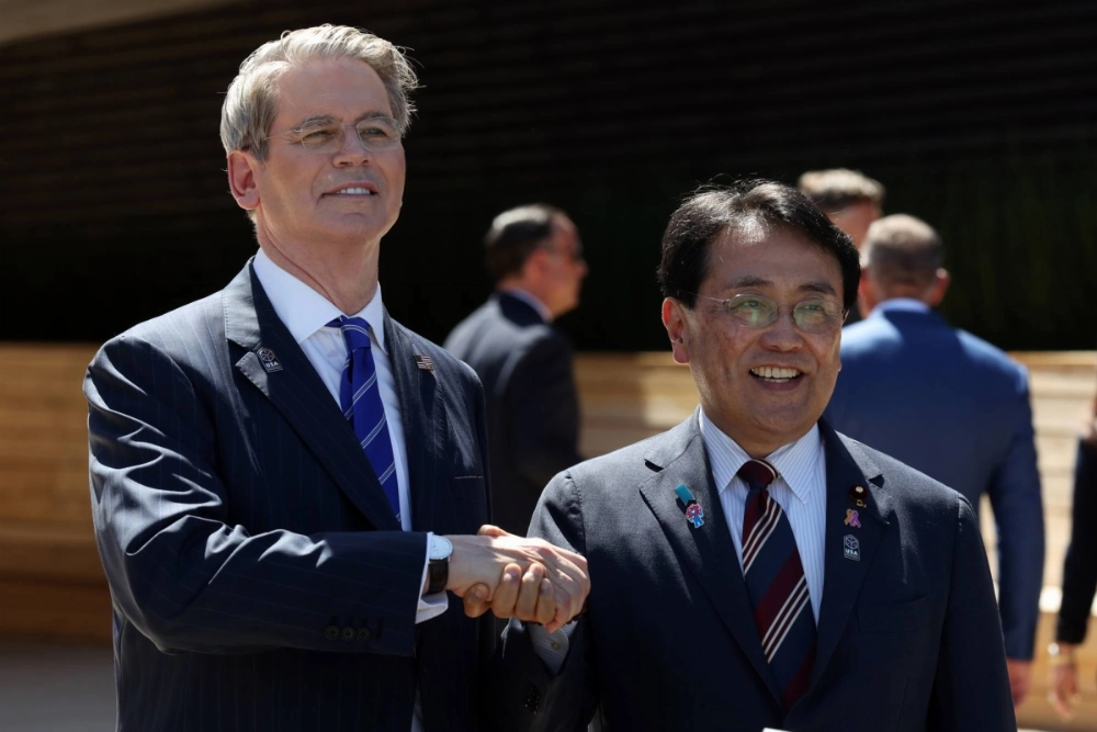 U.S. Treasury Secretary Scott Bessent (left) shakes hands with economic revitalization minister Ryosei Akazawa, Japan's chief tariff negotiator, at the Osaka Expo in the city of Osaka on July 19. U.S. Treasury Secretary Scott Bessent (left) shakes hands with economic revitalization minister Ryosei Akazawa, Japan's chief tariff negotiator, at the Osaka Expo in the city of Osaka on July 19.