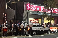 Police officers investigate the area where six passersby were allegedly attacked by a knife-wielding man in Mito, Ibaraki Prefecture, on Monday evening. | Jiji