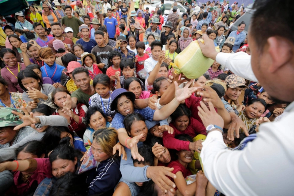 People who fled their homes near the border between Cambodia and Thailand gather to get temporary aid at an evacuation center in Cambodia's Preah Vihear province on Tuesday. People who fled their homes near the border between Cambodia and Thailand gather to get temporary aid at an evacuation center in Cambodia's Preah Vihear province on Tuesday.