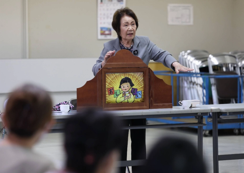 Kyoko Miura presenting a kamishibai picture story about her escape back to Japan from former Manchuria as a young girl after the end of the war, on June 27 in the city of Higashimatsushima, Miyagi Prefecture. Kyoko Miura presenting a kamishibai picture story about her escape back to Japan from former Manchuria as a young girl after the end of the war, on June 27 in the city of Higashimatsushima, Miyagi Prefecture.