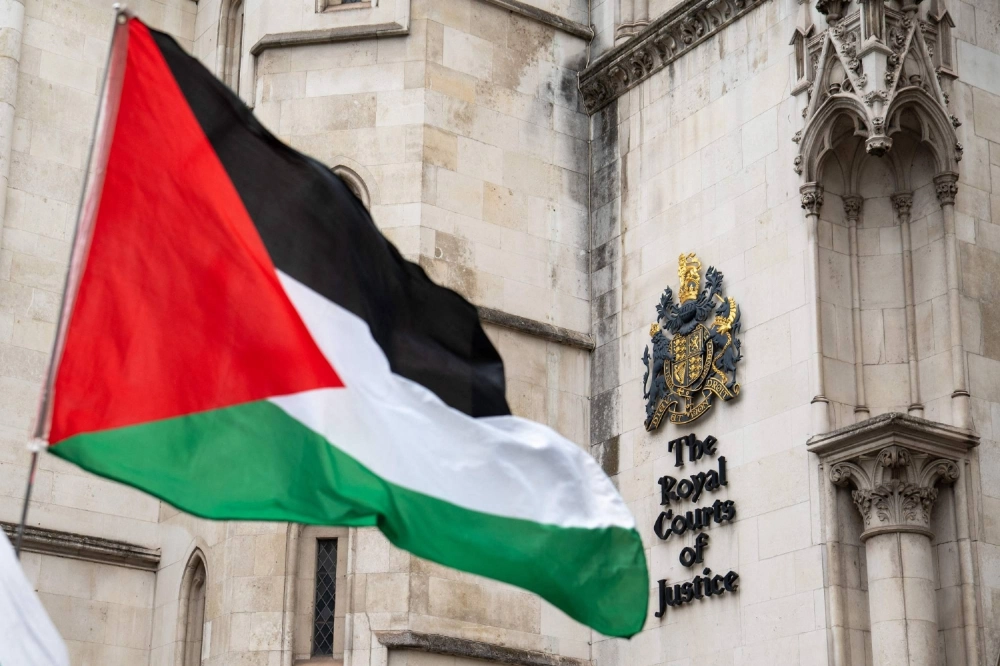 A Palestinian flag is seen held outside the Royal Courts of Justice in London on Wednesday. A Palestinian flag is seen held outside the Royal Courts of Justice in London on Wednesday.