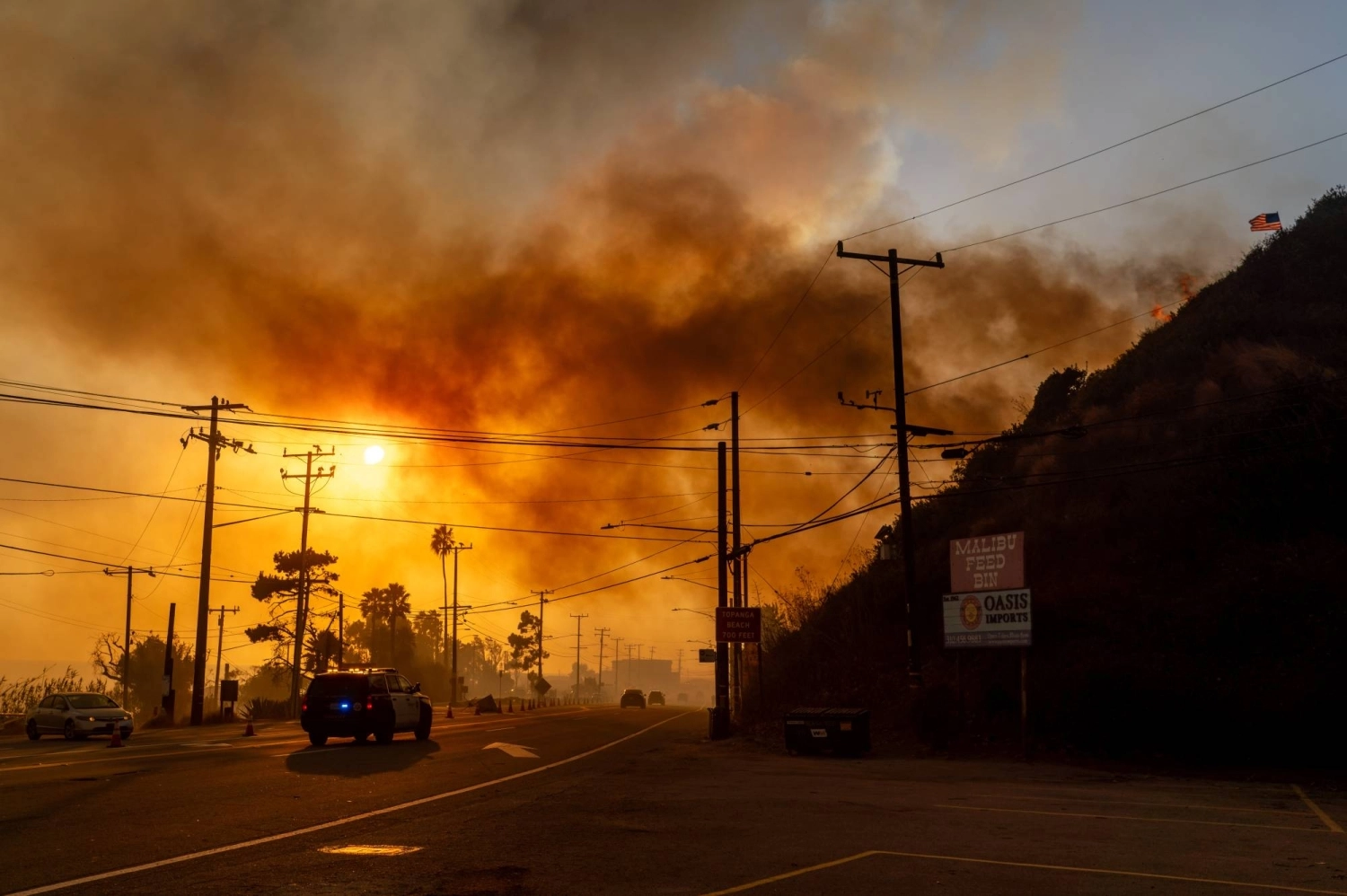 A police vehicle drives past active fire during the Palisades Fire in Los Angeles on Jan. 7. A police vehicle drives past active fire during the Palisades Fire in Los Angeles on Jan. 7.