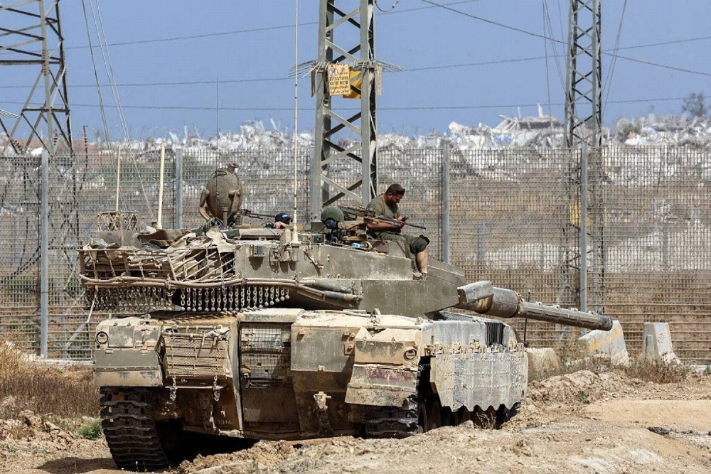 Israeli soldiers drive a tank in southern Israel, on the border with the Gaza Strip, earlier this year.  Israeli soldiers drive a tank in southern Israel, on the border with the Gaza Strip, earlier this year.