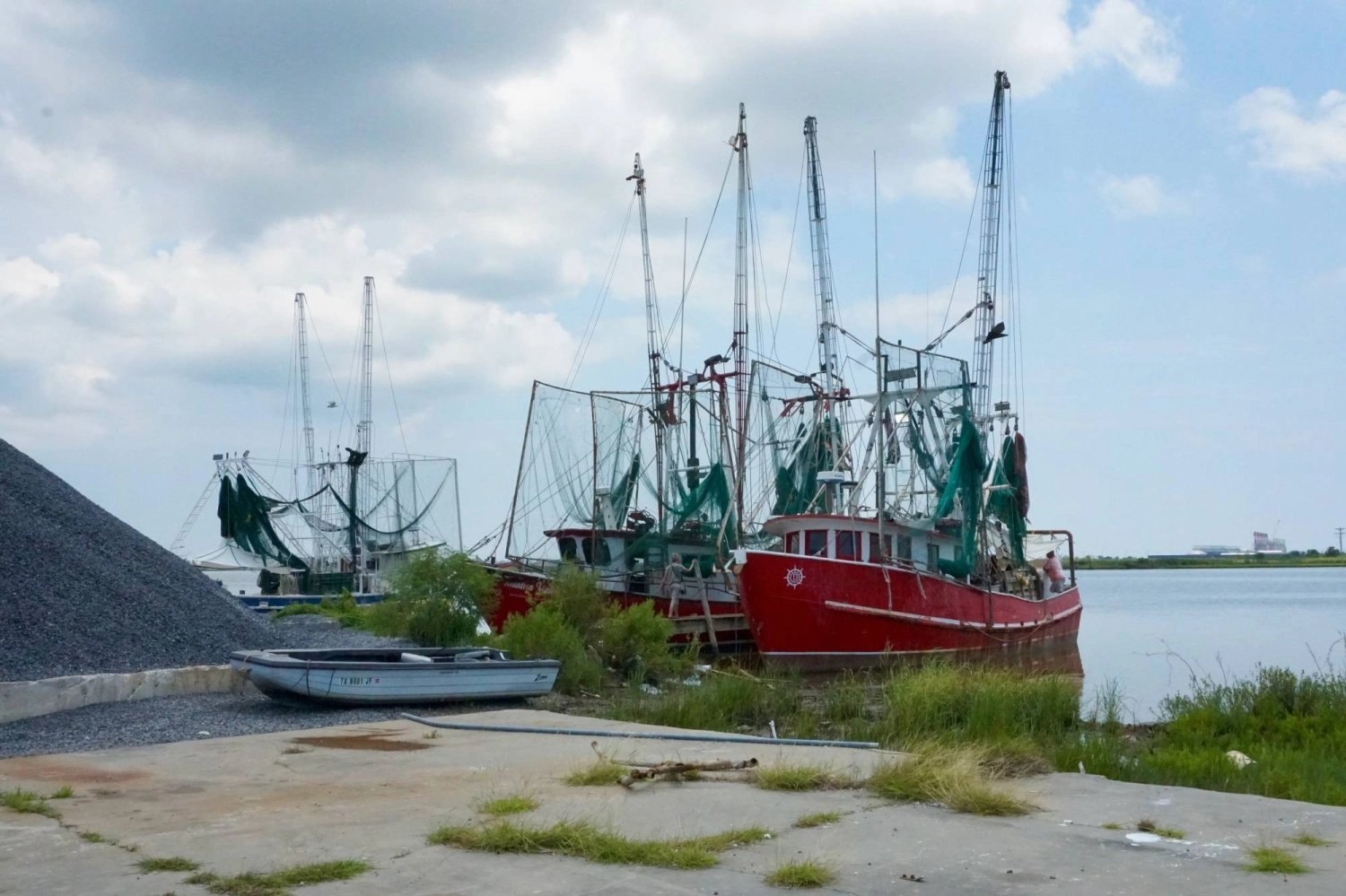 Fishing boats in the Calcasieu Ship Channel, which connects Lake Charles, Louisiana, with the Gulf of Mexico. Since Calcasieu Pass LNG started production in 2022, catches of shrimp, crabs and fish have decreased dramatically year after year, local fishers say. Fishing boats in the Calcasieu Ship Channel, which connects Lake Charles, Louisiana, with the Gulf of Mexico. Since Calcasieu Pass LNG started production in 2022, catches of shrimp, crabs and fish have decreased dramatically year after year, local fishers say.