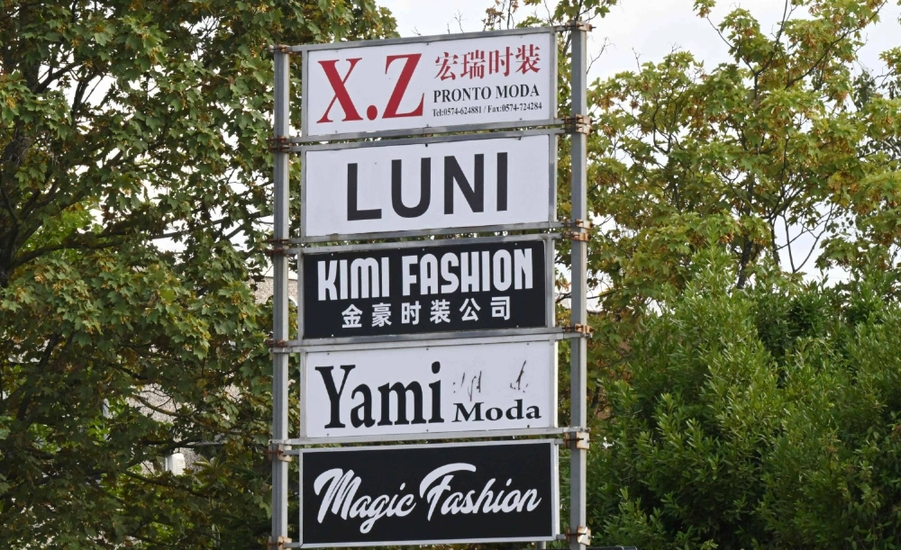 Signs for fast-fashion factories in Prato, Italy, on Friday. Chinese crime groups in the district thrive on the "Prato system" rife with corruption in the fast-fashion sector.  Signs for fast-fashion factories in Prato, Italy, on Friday. Chinese crime groups in the district thrive on the "Prato system" rife with corruption in the fast-fashion sector.