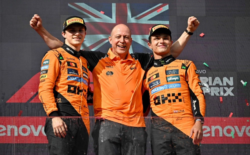 McLaren's Lando Norris (right) and Oscar Piastri (left) stand on the podium with Mark Ingham, the team's head of design, after the Hungarian Grand Prix in Budapest on Sunday. Norris led a 1-2 finish in the race. McLaren's Lando Norris (right) and Oscar Piastri (left) stand on the podium with Mark Ingham, the team's head of design, after the Hungarian Grand Prix in Budapest on Sunday. Norris led a 1-2 finish in the race.
