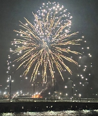 A fire breaks out from a launch barge (bottom) during a fireworks event in Yokohama on Monday evening. | Jiji