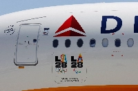 LA28 logos are seen on a Delta Airlines jet carrying American athletes and officials and the Olympic flag as it arrives in Los Angeles, on August 12, 2024.  | Reuters