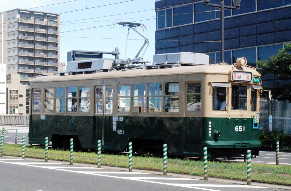 A surviving streetcar from the World War II atomic bombing of the city of Hiroshima runs near the Atomic Bomb Dome in Hiroshima on July 27. A surviving streetcar from the World War II atomic bombing of the city of Hiroshima runs near the Atomic Bomb Dome in Hiroshima on July 27.