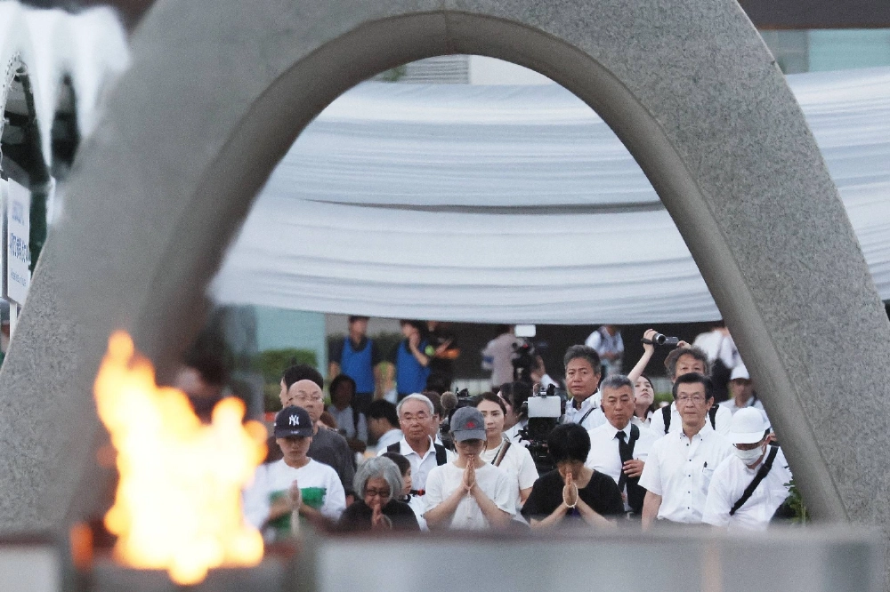 People pray in front of the cenotaph for the atomic bombing victims at Hiroshima Peace Memorial Park in the city of Hiroshima on Wednesday, which marks the 80th anniversary of the bombing. People pray in front of the cenotaph for the atomic bombing victims at Hiroshima Peace Memorial Park in the city of Hiroshima on Wednesday, which marks the 80th anniversary of the bombing.