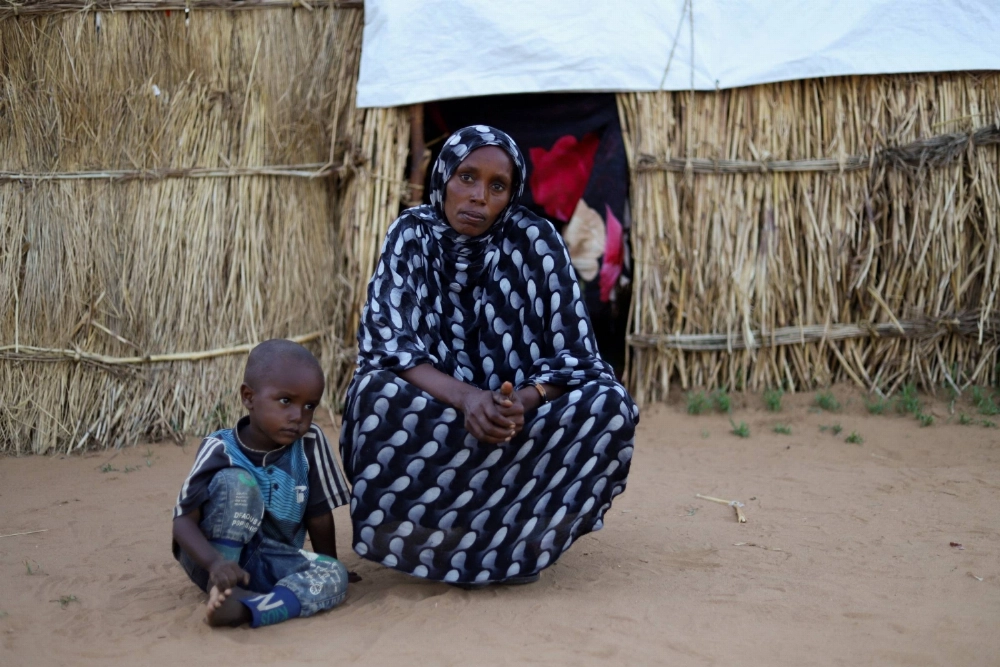A displaced Sudanese mother and one of her children sit inside a camp shelter in Tawila, North Darfur, Sudan, on July 30. A displaced Sudanese mother and one of her children sit inside a camp shelter in Tawila, North Darfur, Sudan, on July 30.