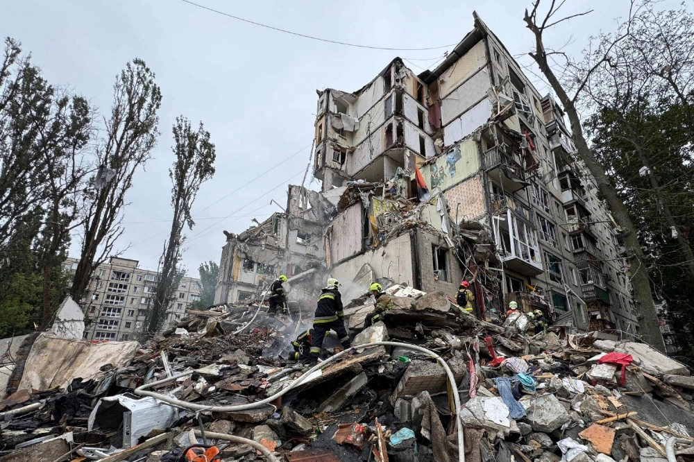 Ukrainian emergency workers scour the rubble of a residential building in Kyiv after a Russian air attack on July 31. Ukrainian emergency workers scour the rubble of a residential building in Kyiv after a Russian air attack on July 31.
