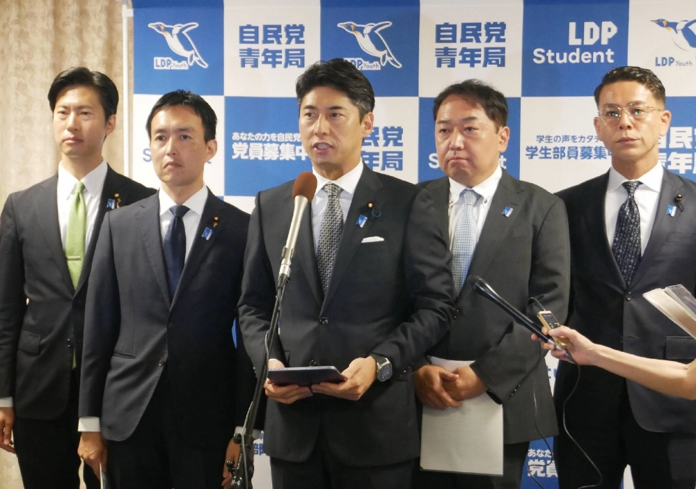 Liberal Democratic Party youth division head Yasutaka Nakasone (center) and other members speak to reporters in Tokyo on July 25. Liberal Democratic Party youth division head Yasutaka Nakasone (center) and other members speak to reporters in Tokyo on July 25.