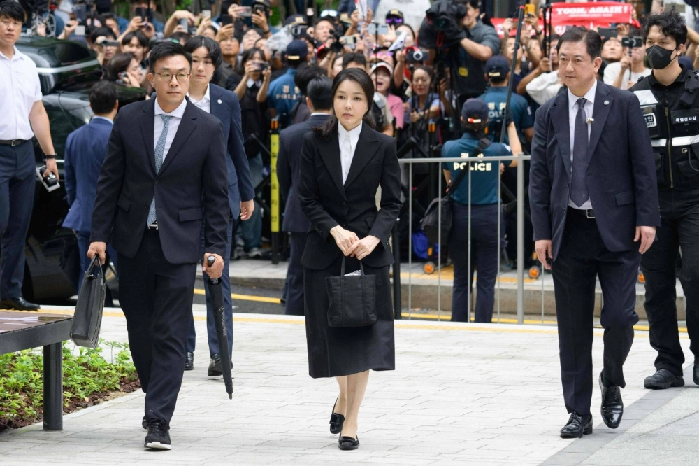 South Korea's former first lady, Kim Keon Hee (center), the wife of impeached former President Yoon Suk Yeol, arrives at the special prosecutor's office in Seoul on Wednesday. South Korea's former first lady, Kim Keon Hee (center), the wife of impeached former President Yoon Suk Yeol, arrives at the special prosecutor's office in Seoul on Wednesday.