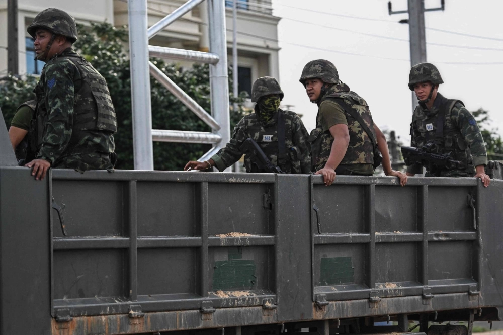 Thai soldiers on the back of an army truck in the border province of Si Sa Ket on July 26.  Thai soldiers on the back of an army truck in the border province of Si Sa Ket on July 26.