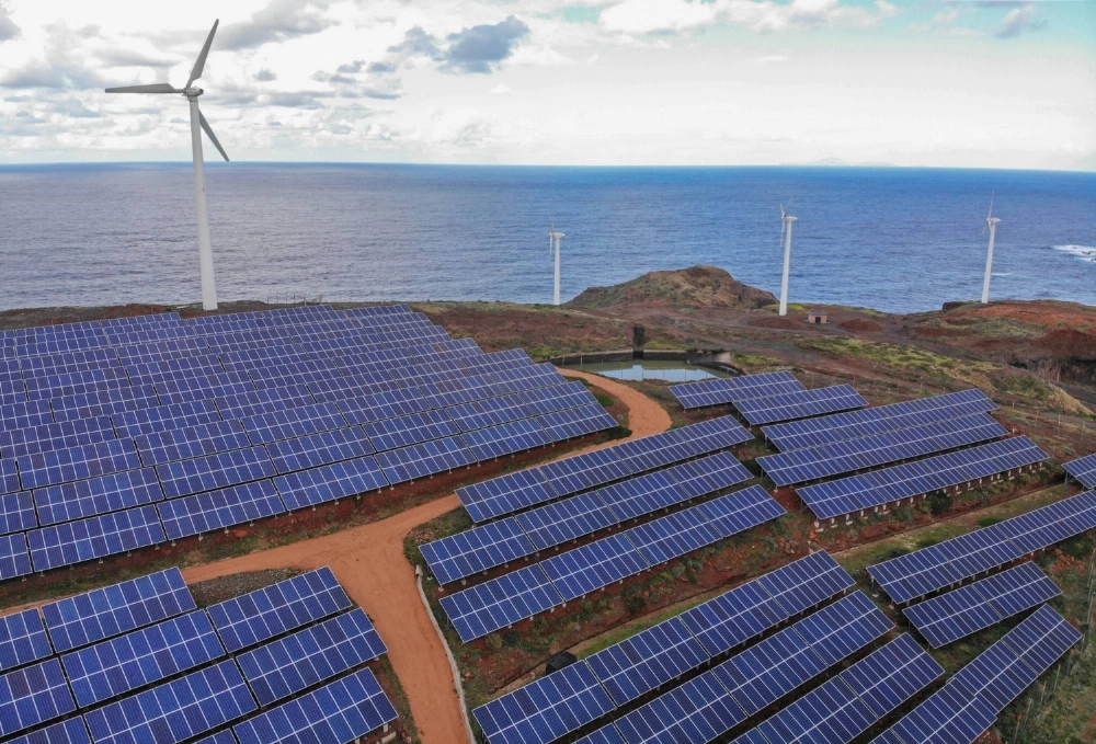 Wind turbines beyond an array of solar panels on the hillside in the Canical district of Madeira, Portugal, on Feb. 9, 2023. Renewables are now among the cheapest forms of electricity, especially after an energy crunch and the Ukraine war bolstered gas, oil and coal. Wind turbines beyond an array of solar panels on the hillside in the Canical district of Madeira, Portugal, on Feb. 9, 2023. Renewables are now among the cheapest forms of electricity, especially after an energy crunch and the Ukraine war bolstered gas, oil and coal.