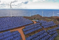 Wind turbines beyond an array of solar panels on the hillside in the Canical district of Madeira, Portugal, on Feb. 9, 2023. Renewables are now among the cheapest forms of electricity, especially after an energy crunch and the Ukraine war bolstered gas, oil and coal. | Bloomberg