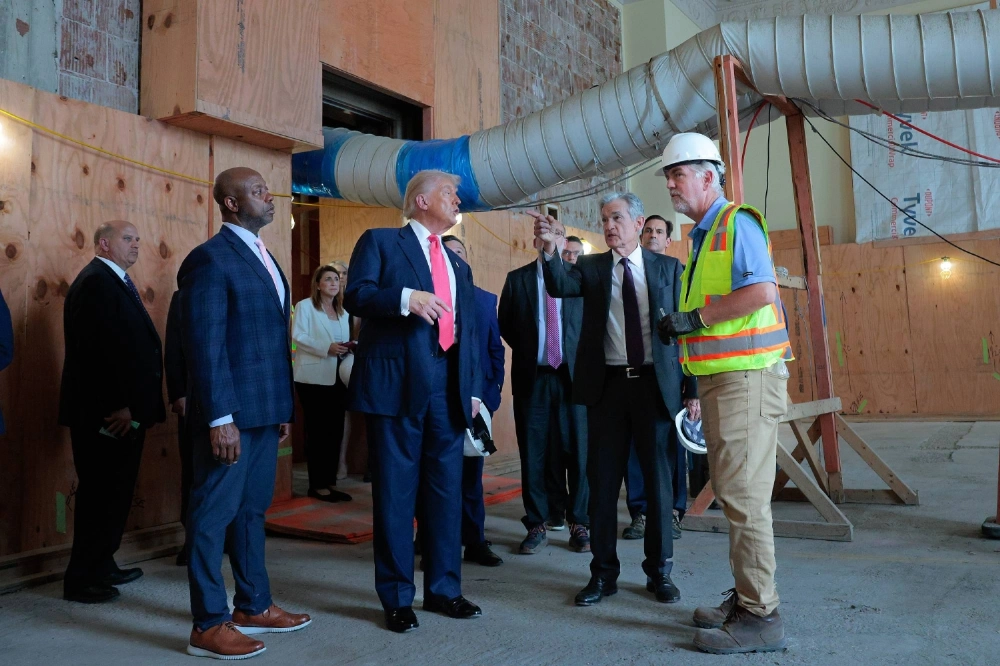 Federal Reserve Chair Jerome Powell (center left) talks to U.S. President Donald Trump and Sen. Tim Scott as they tour the Federal Reserve’s renovation project in Washington on July 24. Federal Reserve Chair Jerome Powell (center left) talks to U.S. President Donald Trump and Sen. Tim Scott as they tour the Federal Reserve’s renovation project in Washington on July 24.