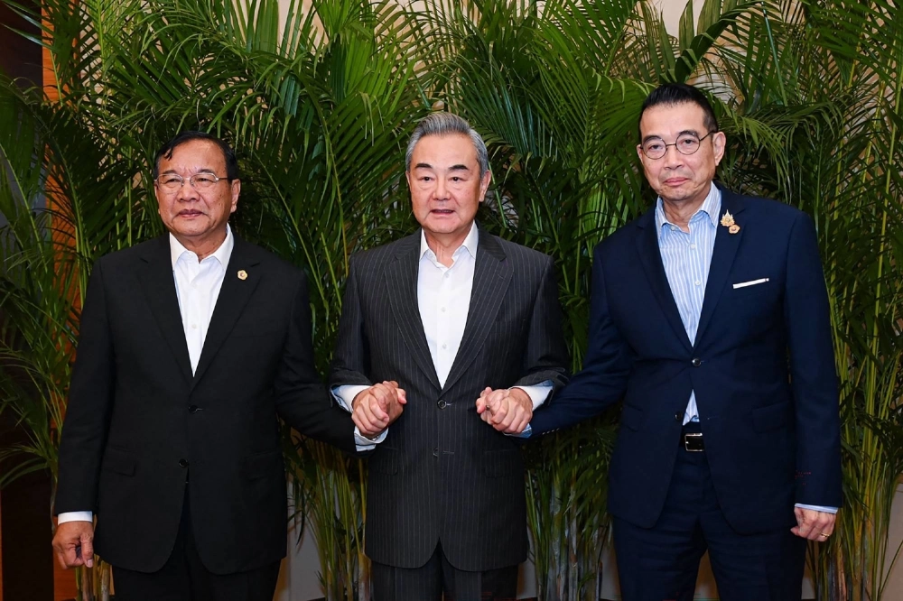 Thailand's Foreign Minister Maris Sangiampongsa (right) with China's Foreign Minister Wang Yi (center) and Cambodia's Foreign Minister Prak Sokhonn as they meet in Anning in China's Yunnan province on Thursday. Thailand's Foreign Minister Maris Sangiampongsa (right) with China's Foreign Minister Wang Yi (center) and Cambodia's Foreign Minister Prak Sokhonn as they meet in Anning in China's Yunnan province on Thursday.