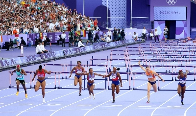 Athletes compete in the final of the women's 100 meter hurdles at the Paris Olympics in August last year.  Athletes compete in the final of the women's 100 meter hurdles at the Paris Olympics in August last year.