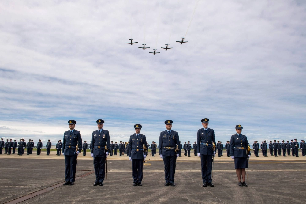 A T-6C Texan aircraft flying above a graduating parade at the Royal New Zealand Air Force (RNZAF) Base Ohakea, located north-west of the city of Palmerston North in New Zealand on Monday. A T-6C Texan aircraft flying above a graduating parade at the Royal New Zealand Air Force (RNZAF) Base Ohakea, located north-west of the city of Palmerston North in New Zealand on Monday.