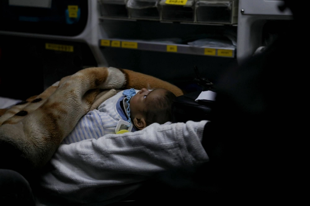 A Palestinian child in need of medical treatment is evacuated through the King Hussein Bridge crossing in Jordan on March 4. A Palestinian child in need of medical treatment is evacuated through the King Hussein Bridge crossing in Jordan on March 4.