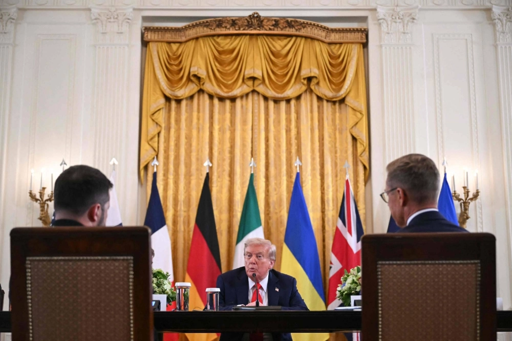 Ukrainian leader Volodymyr Zelenskyy (left) and Finnish President Alexander Stubb (right) look on as U.S. President Donald Trump speaks during a meeting with European leaders in the East Room of the White House in Washington on Monday. Ukrainian leader Volodymyr Zelenskyy (left) and Finnish President Alexander Stubb (right) look on as U.S. President Donald Trump speaks during a meeting with European leaders in the East Room of the White House in Washington on Monday.