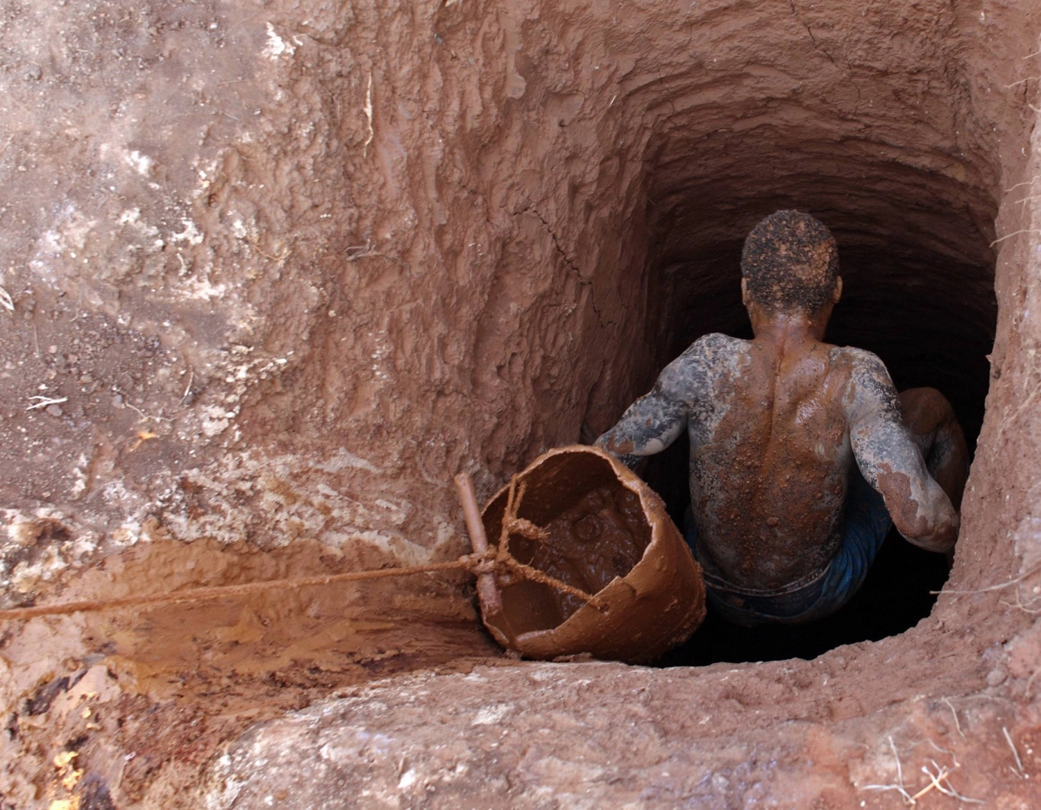 A gold miner climbs down into a mine shaft in Manica in 2010. A gold miner climbs down into a mine shaft in Manica in 2010.