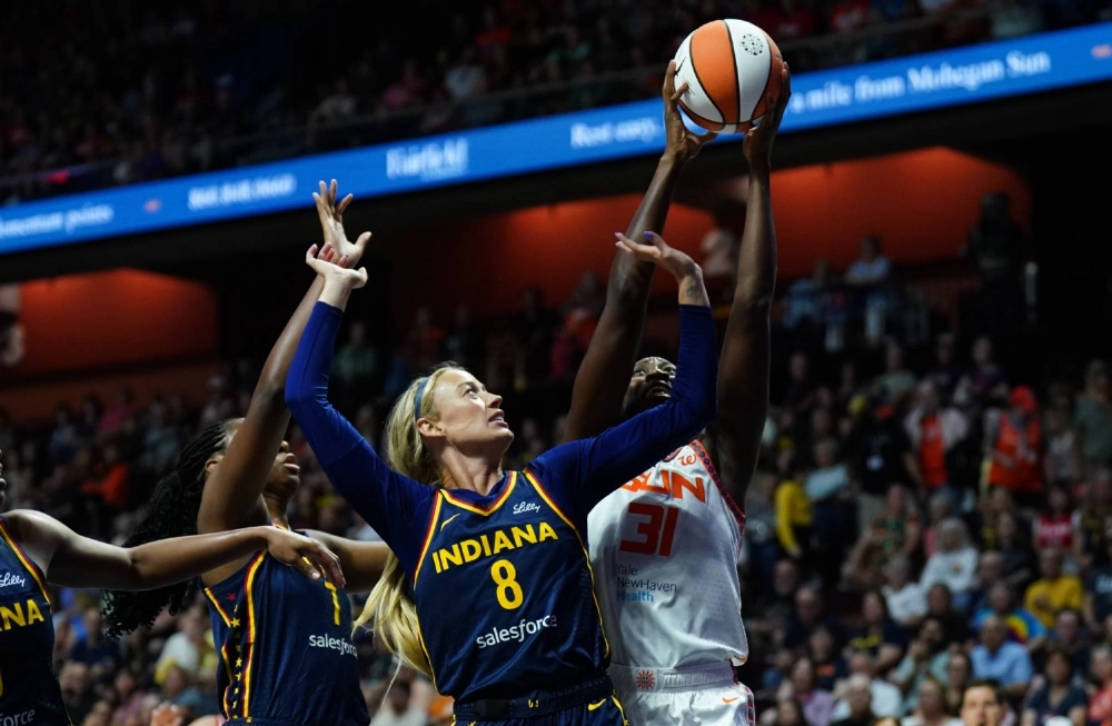 Fever guard Sophie Cunningham (front) and Sun center Tina Charles contest the ball in the first half at Mohegan Sun Arena in Connecticut on Tuesday. Fever guard Sophie Cunningham (front) and Sun center Tina Charles contest the ball in the first half at Mohegan Sun Arena in Connecticut on Tuesday.