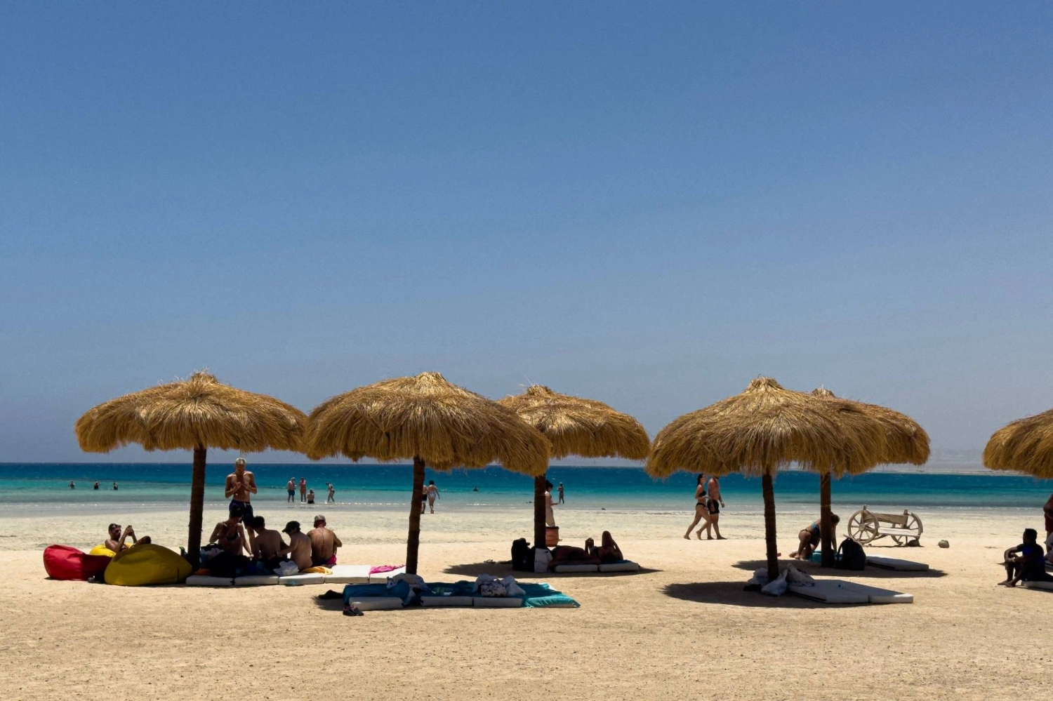 People sit under parasols at the Ras Hankorab beach. Legal and environmental uncertainty remains at the nature reserve after construction of a resort was halted but not permanently canceled. People sit under parasols at the Ras Hankorab beach. Legal and environmental uncertainty remains at the nature reserve after construction of a resort was halted but not permanently canceled.