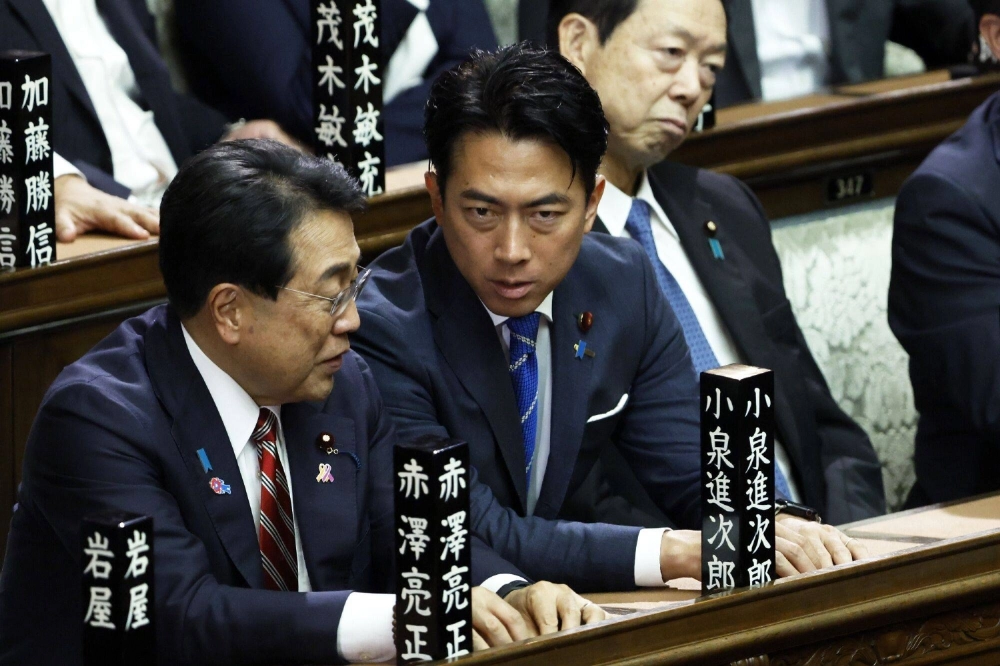 Farm minister Shinjiro Koizumi (center) attends a  Lower House session on Aug. 1. Locking Koizumi into the Cabinet is Prime Minister Shigeru Ishiba’s way of turning a potential rival into a team player, according to one expert. Farm minister Shinjiro Koizumi (center) attends a  Lower House session on Aug. 1. Locking Koizumi into the Cabinet is Prime Minister Shigeru Ishiba’s way of turning a potential rival into a team player, according to one expert.