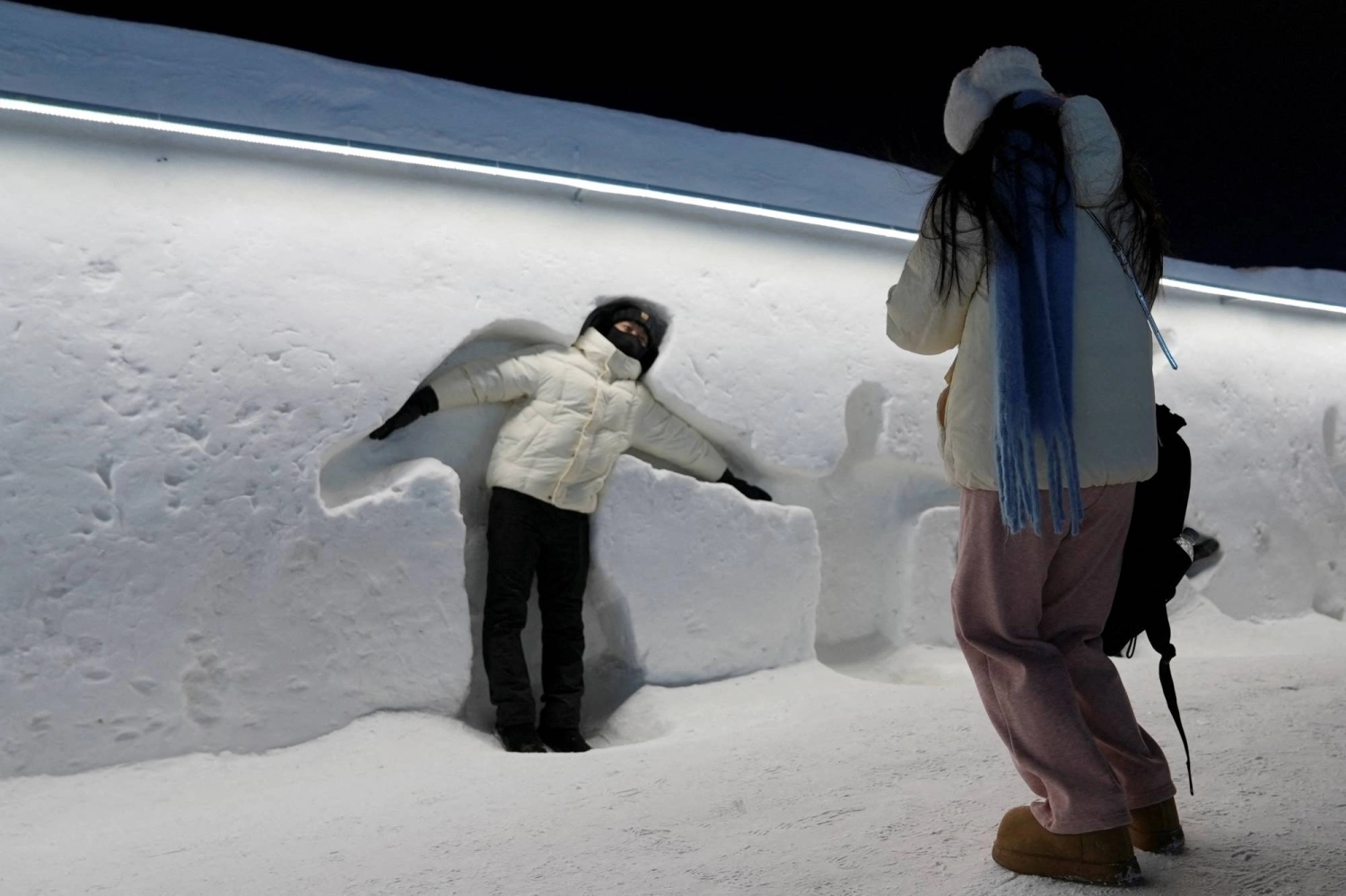 A visitor poses for pictures at the Harbin International Ice and Snow Festival in Harbin, China, in January. A visitor poses for pictures at the Harbin International Ice and Snow Festival in Harbin, China, in January.