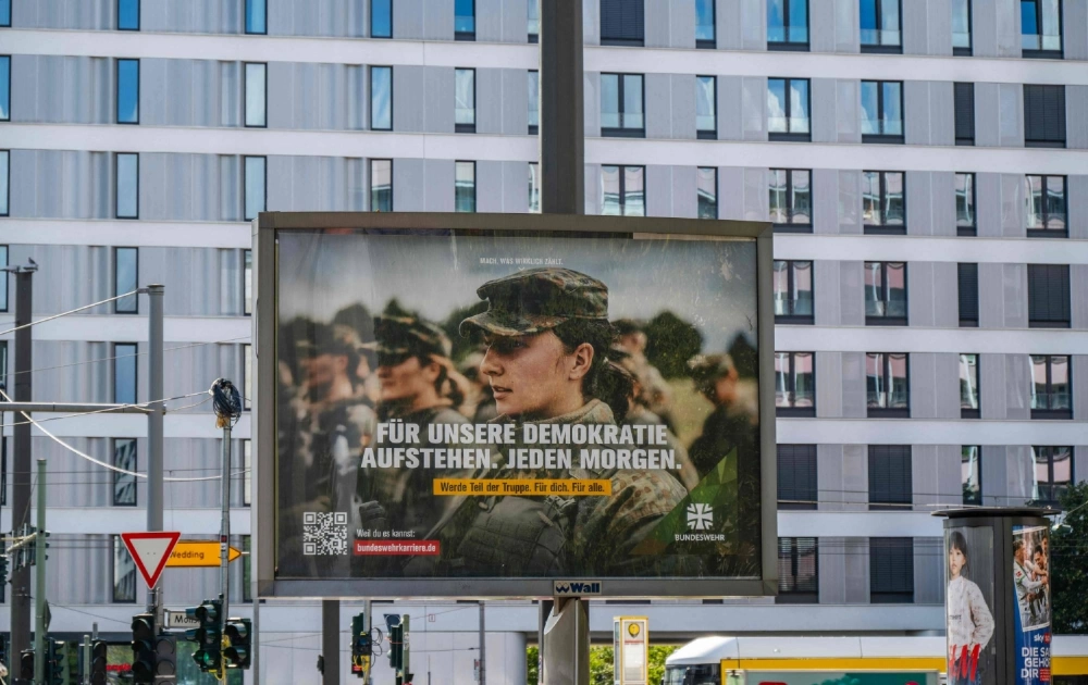 A billboard displays an ad for the German armed forces in Berlin on Wednesday. The advertising slogan reads: "Standing up for our democracy. Every morning." A billboard displays an ad for the German armed forces in Berlin on Wednesday. The advertising slogan reads: "Standing up for our democracy. Every morning."