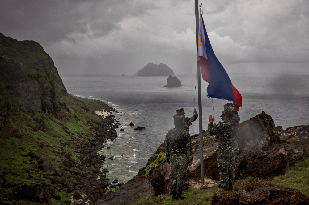 Filipino soldiers take part in a flag-raising ceremony on Mavulis Island during a visit by the Philippines' Armed Forces chief of staff, in Batanes, the Philippines, in June 2023. Batanes, a group of idyllic islands at the country’s northernmost tip, sits about 160 kilometers from Taiwan.   Filipino soldiers take part in a flag-raising ceremony on Mavulis Island during a visit by the Philippines' Armed Forces chief of staff, in Batanes, the Philippines, in June 2023. Batanes, a group of idyllic islands at the country’s northernmost tip, sits about 160 kilometers from Taiwan.