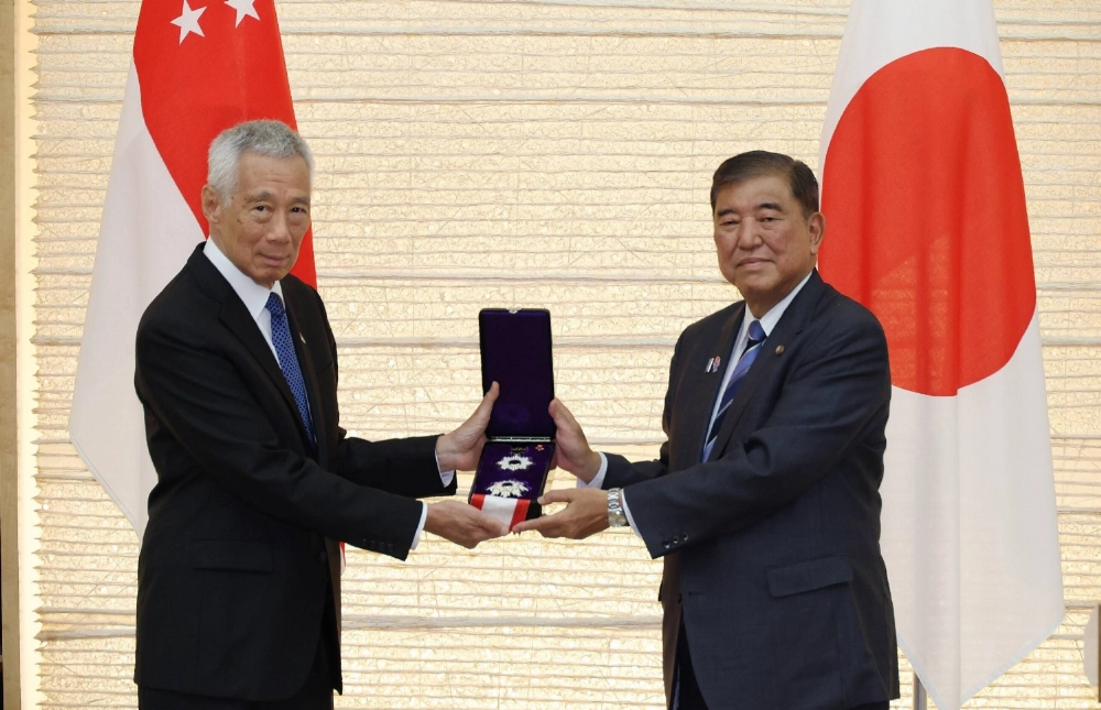 Prime Minister Shigeru Ishiba presents Singapore's Senior Minister Lee Hsien Loong (left) with the Grand Cordon of the Order of the Rising Sun on Monday at the Prime Minister's Office. Prime Minister Shigeru Ishiba presents Singapore's Senior Minister Lee Hsien Loong (left) with the Grand Cordon of the Order of the Rising Sun on Monday at the Prime Minister's Office.