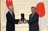 Prime Minister Shigeru Ishiba presents Singapore's Senior Minister Lee Hsien Loong (left) with the Grand Cordon of the Order of the Rising Sun on Monday at the Prime Minister's Office. | JIJI