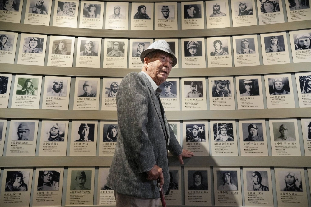 Kunitake Toriya, a former corporal in the Imperial Japanese Army who had trained for a suicide attack mission, speaks about his wartime experiences in front of the photographs of his comrades at Tachiarai Peace Memorial Museum in Chikuzen, Fukuoka Prefecture, in June. Kunitake Toriya, a former corporal in the Imperial Japanese Army who had trained for a suicide attack mission, speaks about his wartime experiences in front of the photographs of his comrades at Tachiarai Peace Memorial Museum in Chikuzen, Fukuoka Prefecture, in June.