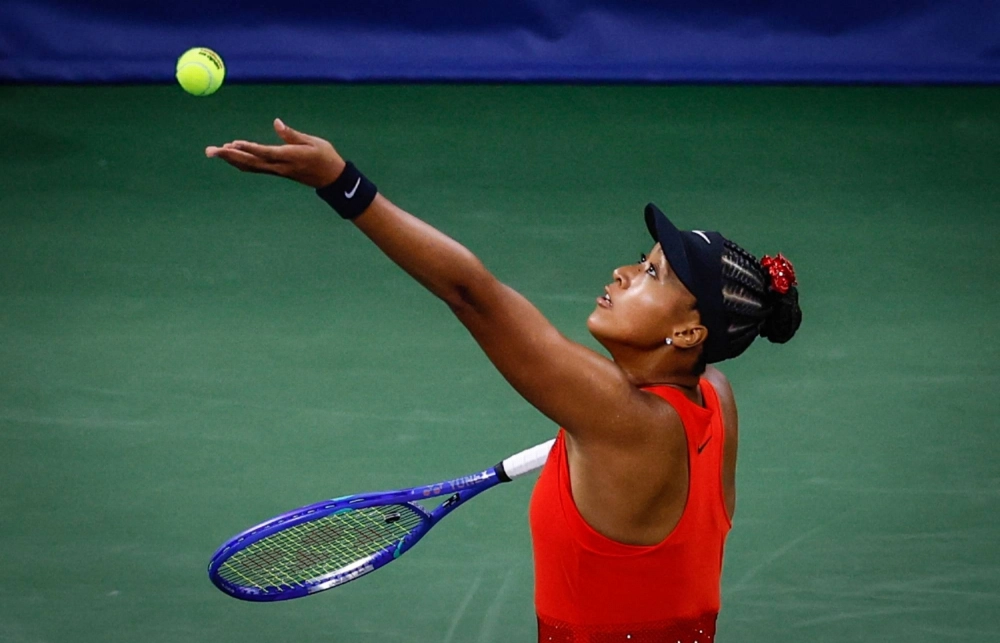 Naomi Osaka serves the ball to Greet Minnen during their first round match at the U.S. Open in New York on Tuesday. Naomi Osaka serves the ball to Greet Minnen during their first round match at the U.S. Open in New York on Tuesday.