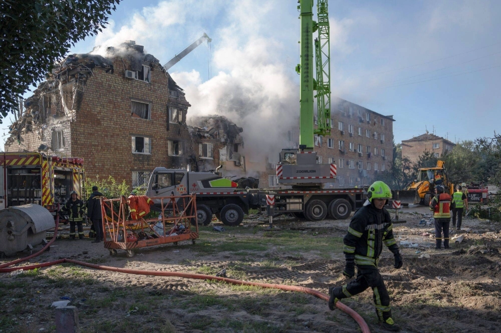 Emergency service workers at the site a Russian airstrike on a residential building in Kyiv on Thursday Emergency service workers at the site a Russian airstrike on a residential building in Kyiv on Thursday