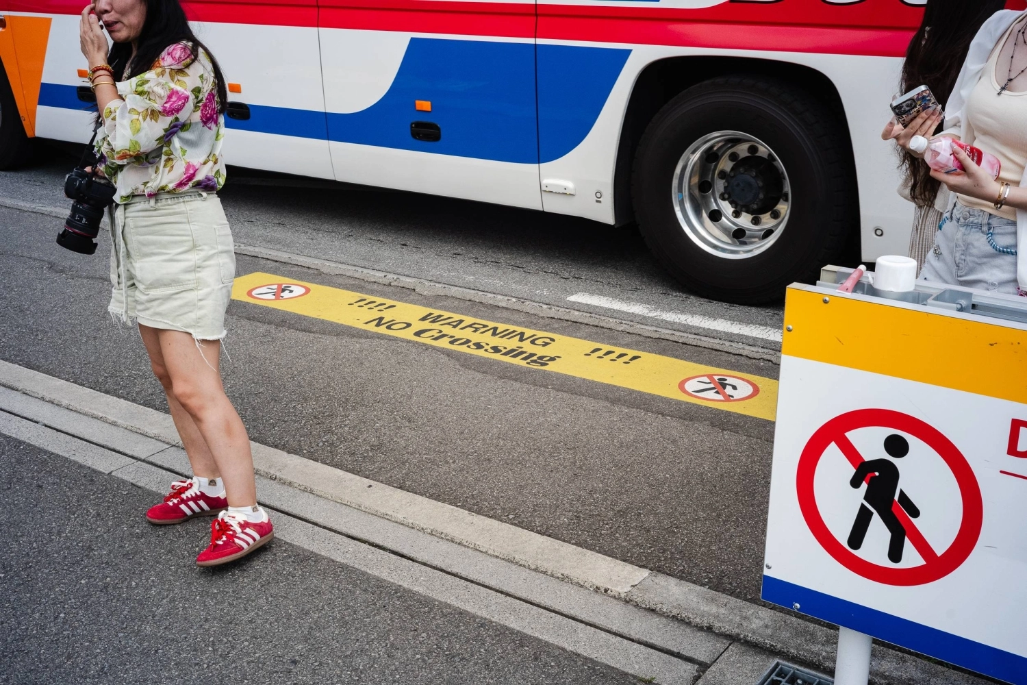 Signs warn tourists against crossing the road in front of the Lawson outlet in Kawaguchiko. Signs warn tourists against crossing the road in front of the Lawson outlet in Kawaguchiko.