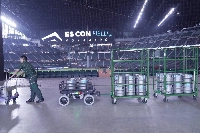 Work assistance robot "Suppot" helps transport beer kegs at the Es Con Field Hokkaido stadium. | YAMATO HOLDINGS / VIA JIJI