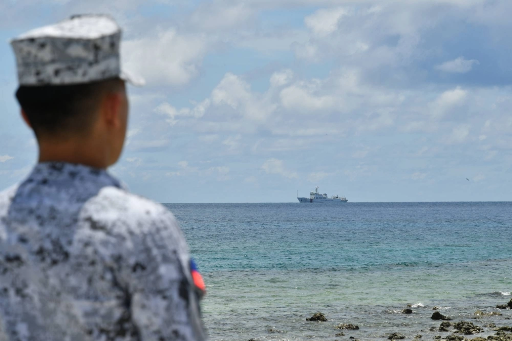 A Philippine Navy sailor looks at a China Coast Guard vessel just off the coast of Pag-asa Island in the disputed South China Sea last month. A Philippine Navy sailor looks at a China Coast Guard vessel just off the coast of Pag-asa Island in the disputed South China Sea last month.