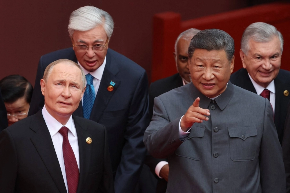 Russian President Vladimir Putin speaks with Chinese leader Xi Jinping after a group photograph before a military parade marking the 80th anniversary of victory over Japan and the end of World War II, in Beijing, on Wednesday.  Russian President Vladimir Putin speaks with Chinese leader Xi Jinping after a group photograph before a military parade marking the 80th anniversary of victory over Japan and the end of World War II, in Beijing, on Wednesday.