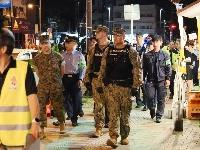 U.S. military personnel join Japanese officials and residents for a one-off joint nighttime patrol on the streets of the city of Okinawa in April, following sexual assault cases involving U.S. service members. | JIJI