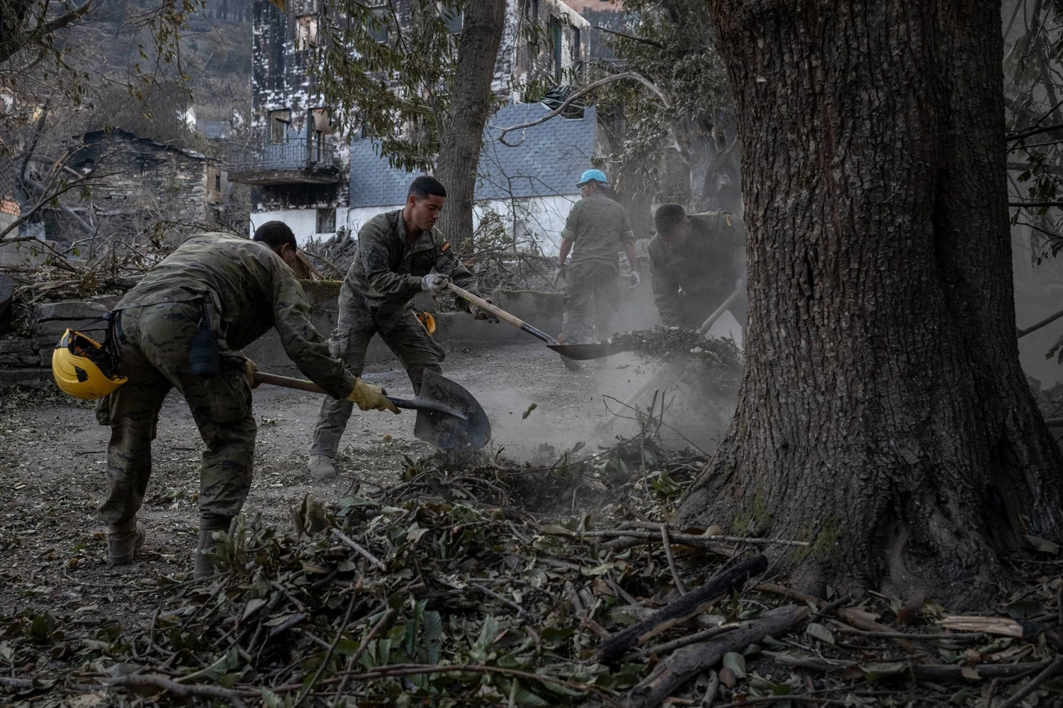 Spanish soldiers engage in cleanup operations following a wildfire in San Vicente De Leira on Aug. 21. Spanish soldiers engage in cleanup operations following a wildfire in San Vicente De Leira on Aug. 21.