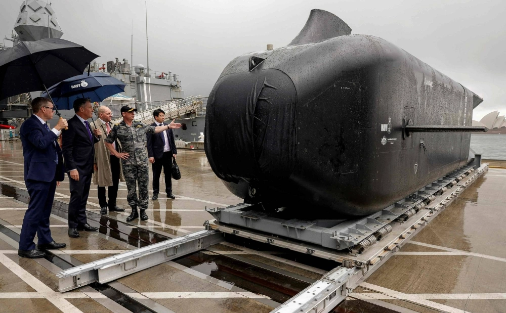 Australian defence chief Richard Marles (second from left), Minister for Defence Industry Pat Conroy (left), and navy chief Vice Adm. Mark Hammond inspect a "Ghost Shark"-class autonomous undersea vehicle at a naval base in Sydney on Wednesday. Australian defence chief Richard Marles (second from left), Minister for Defence Industry Pat Conroy (left), and navy chief Vice Adm. Mark Hammond inspect a "Ghost Shark"-class autonomous undersea vehicle at a naval base in Sydney on Wednesday.