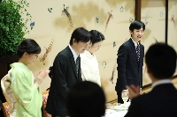 Prince Hisahito (right) smiles during a luncheon celebrating his coming of age in Minato Ward, Tokyo, on Wednesday. | Pool / via Jiji