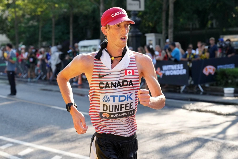 Evan Dunfee competes during the 35-kilometer race walk during the world championships in Budapest on Aug. 24, 2023. Evan Dunfee competes during the 35-kilometer race walk during the world championships in Budapest on Aug. 24, 2023.