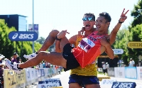 Gold medalist Toshikazu Yamanishi (front) celebrates with bronze medalist Perseus Karlstrom after the men's 20-kilometer race walk at the 2022 world championships.  | REUTERS