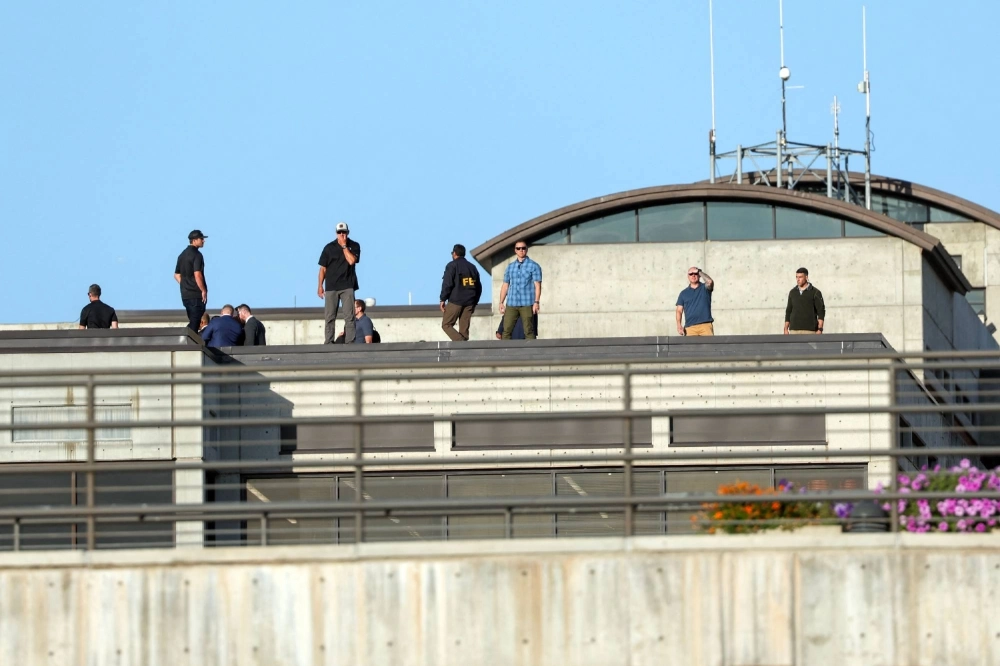 FBI agents inspect a rooftop on Thursday at the scene where, a day earlier, youth activist and influencer Charlie Kirk was shot during a public event at Utah Valley University in Orem, Utah.  FBI agents inspect a rooftop on Thursday at the scene where, a day earlier, youth activist and influencer Charlie Kirk was shot during a public event at Utah Valley University in Orem, Utah.